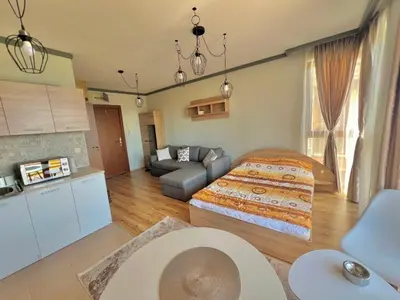 a bedroom with a bed and a living room at St Ivan Ski and Spa Studio in Bansko