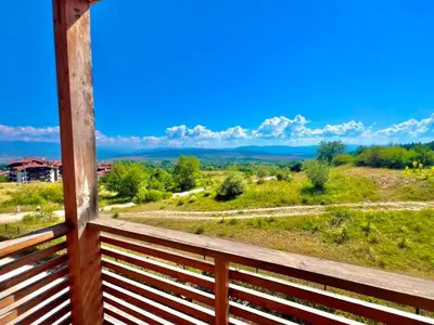 a view from the porch of a house with a wooden railing at St Ivan Ski and Spa Studio in Bansko