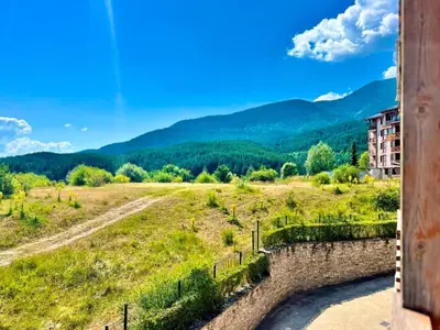 a view of a field with mountains in the background at St Ivan Ski and Spa Studio in Bansko