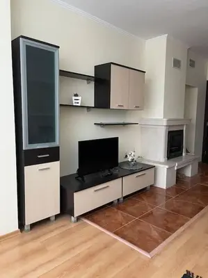 a living room with a flat screen tv in a room at Прекрасно място за нощувки в Пампорово in Pamporovo