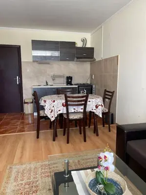 a kitchen with a table and chairs in a living room at Чудесно място за нощувки в Пампорово in Pamporovo
