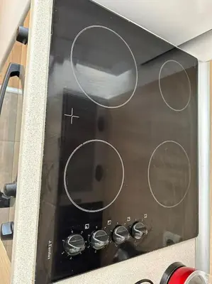 a toaster oven with four knobs on it at Cozy apartmen with Mountain view in Bansko