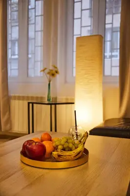 a tray of fruit on a table with a candle at Central Luxury Cozy Modern Apartment in Sofia