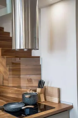 a kitchen with a counter with a bowl and utensils at Host2U Penthouse Sauna, Jacuzzi, Fireplace in Bansko