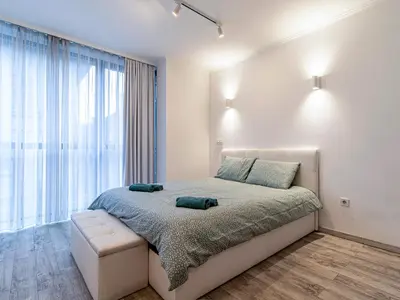 a bedroom with a bed and a large window at Stay Inspired - Sofia Retreat in Sofia