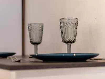 two wine glasses sitting on a table with a plate at Stay Inspired - Sofia Retreat in Sofia