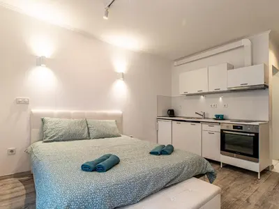 a bedroom with a bed with two blue towels on it at Stay Inspired - Sofia Retreat in Sofia