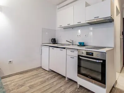 a kitchen with white cabinets and a stove top oven at Stay Inspired - Sofia Retreat in Sofia