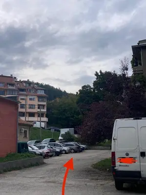 a van parked in a parking lot with an orange arrow at Groovy Olive Apartment in Troyan