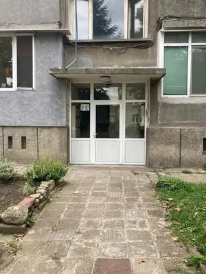 a front door of a house with a stone driveway at Groovy Olive Apartment in Troyan