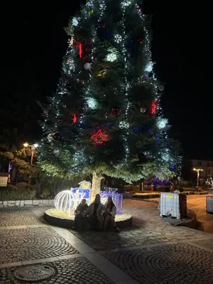 a group of people sitting under a christmas tree at Aspen golf & Ski resort 2 bedroom apartment E002 in Razlog