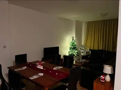 a living room with a table and a christmas tree at Aspen golf & Ski resort 2 bedroom apartment E002 in Razlog