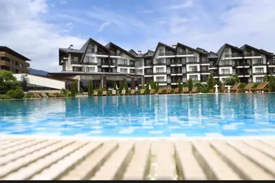 a large swimming pool in front of a building at Aspen golf & Ski resort 2 bedroom apartment E002 in Razlog