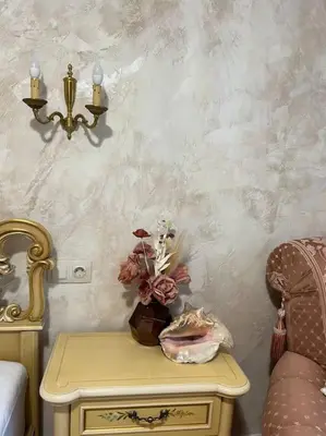 a table with a vase on it next to a bed at Ellie Soe Apartment Free parking 5 min to Metro in Sofia