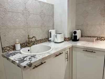 a bathroom with a sink and a counter top at Ellie Soe Apartment Free parking 5 min to Metro in Sofia