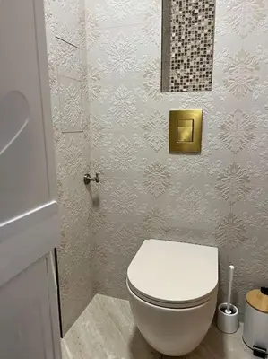 a bathroom with a white toilet in a room at Ellie Soe Apartment Free parking 5 min to Metro in Sofia