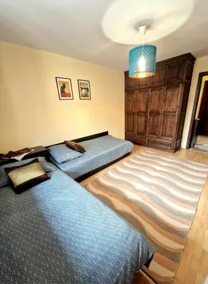 a bedroom with two beds and a large rug at Mountain View Home Maggie in Bansko