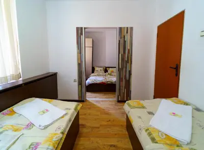 a small room with two beds and a mirror at Вила Горски Кът in Yavrovo