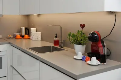 a kitchen counter with a sink and a red mixer at Elit Park apartment Bright & Cozy in Plovdiv