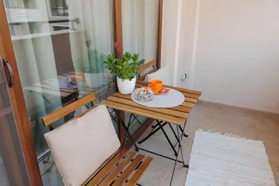 a small table with two chairs and a plate of food on it at Elit Park apartment Bright & Cozy in Plovdiv