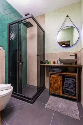 a bathroom with a shower and a toilet and a mirror at Casa di Marko Stylish apt in the Center in Plovdiv