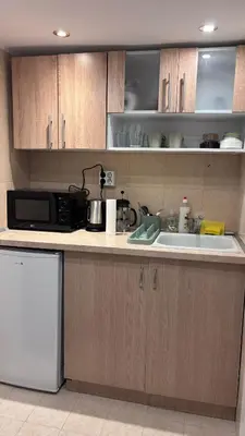 a kitchen with a sink and a microwave at Studio in the heart of Sofia in Sofia