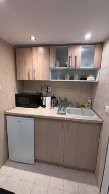 a kitchen with a sink and a microwave at Studio in the heart of Sofia in Sofia