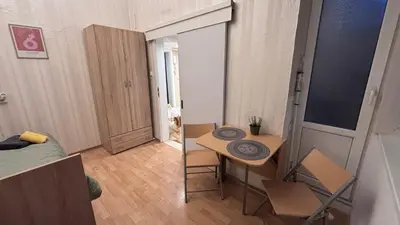 a small apartment with a small table and a room at Studio in the heart of Sofia in Sofia