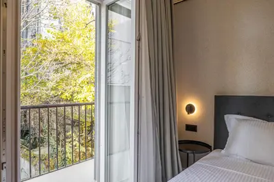 a bedroom with a bed and a large window at M star rooms, Private Parking, Sofia TOP CENTER in Sofia