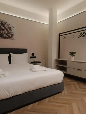 a bedroom with a large white bed and a dresser at M star rooms, Private Parking, Sofia TOP CENTER in Sofia