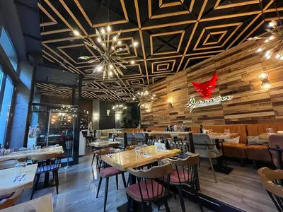 a restaurant with wooden ceilings and tables and chairs at M star rooms, Private Parking, Sofia TOP CENTER in Sofia