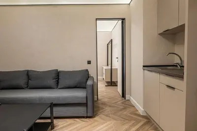 a living room with a couch and a kitchen at M star rooms, Private Parking, Sofia TOP CENTER in Sofia