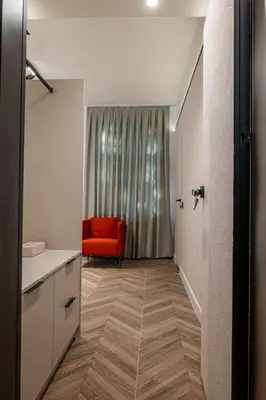 a bathroom with a red chair in a room at M star rooms, Private Parking, Sofia TOP CENTER in Sofia