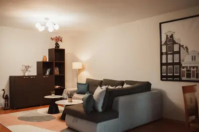 a living room with a couch and a table at Apartment Rhea with Terrace & Parking in Plovdiv