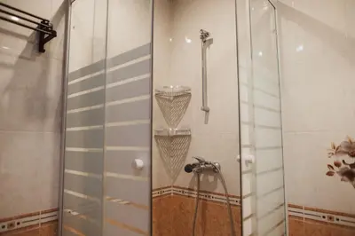 a shower in a bathroom with a shower head at Apartment Rhea with Terrace & Parking in Plovdiv