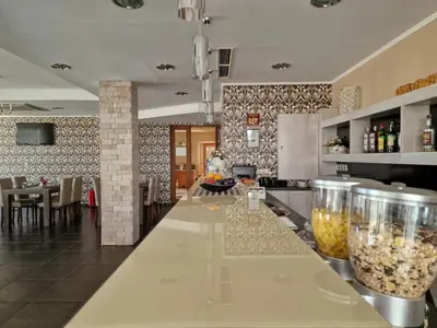 a kitchen with a bar with glasses on it at Айляк Клуб Хисаря - Бутиков Хотел&СПА с Elegant Ultra All Inclusive in Hisarya