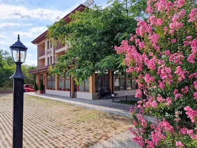 a street light in front of a building with pink flowers at Айляк Клуб Хисаря - Бутиков Хотел&СПА с Elegant Ultra All Inclusive in Hisarya