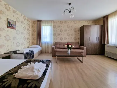 a hotel room with a bed and a couch at Айляк Клуб Хисаря - Бутиков Хотел&СПА с Elegant Ultra All Inclusive in Hisarya