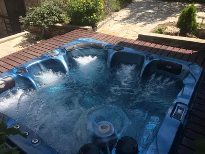 a jacuzzi tub with water in it at Mira Guest House in Dobrinishte
