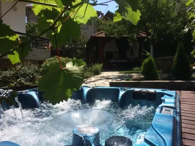 a water feature in a yard with a fountain at Mira Guest House in Dobrinishte