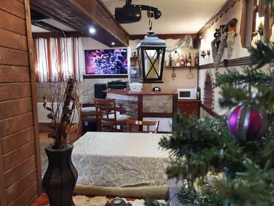 a kitchen and dining room with a dining table and a dining room at Mira Guest House in Dobrinishte
