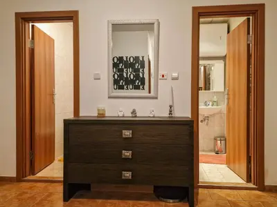 a bathroom with a sink and a dresser with a mirror at Cozy 2-Bedroom Stay with Parking in OLD INN Bansko by Flat Mаnager in Bansko