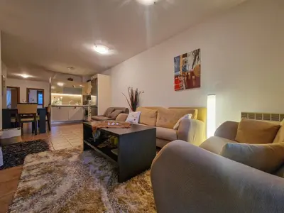 a living room with two couches and a table at Cozy 2-Bedroom Stay with Parking in OLD INN Bansko by Flat Mаnager in Bansko