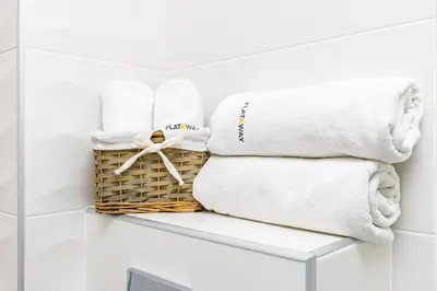 a basket of towels on a shelf in a bathroom at Bright Windowed Studio 10 mins to the City Centre by Flat Mаnager in Plovdiv