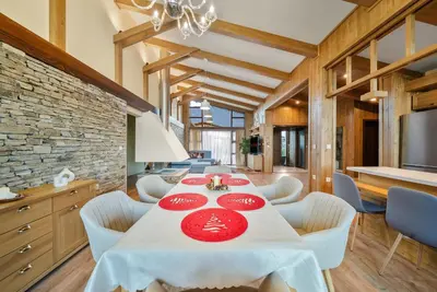 a dining room with a table with red plates on it at Bansko Lux Villas for Ski & Chill in Razlog