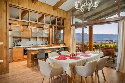 a kitchen and dining room with a table and chairs at Bansko Lux Villas for Ski & Chill in Razlog