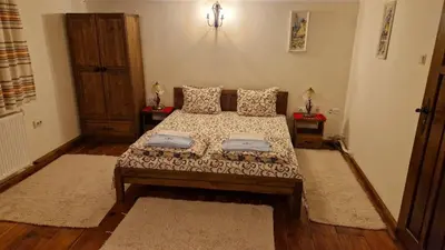 a bedroom with a bed with two pillows at Melnik Pyramids Guesthouse in Zlatkov Chiflik