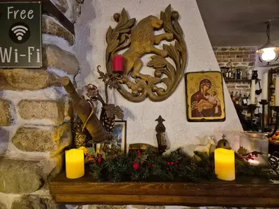 a counter with candles and christmas decorations on it at Melnik Pyramids Guesthouse in Zlatkov Chiflik