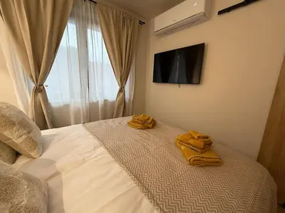 a bedroom with a bed with two towels on it at Cozy design 1 bedroom apartment in Bansko
