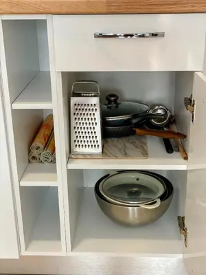 a cupboard with a pot and a pan and a bowl at One-bedroom Apartment at Belvedere Holiday Club Complex in Bansko